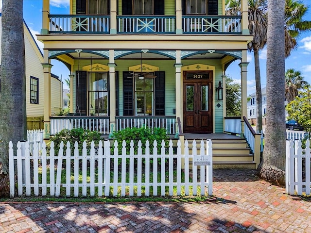 1427 Winnie St, Galveston, TX 77550 - view of exterior entry featuring a porch, a balcony, and fence