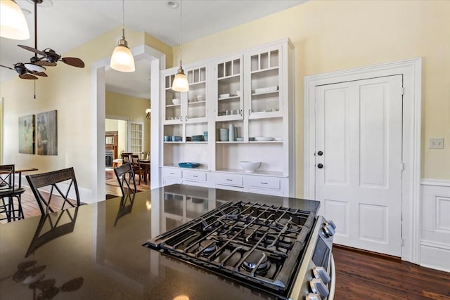 1427 Winnie St, Galveston, TX 77550 - kitchen with a ceiling fan, dark wood finished floors, pendant lighting, white cabinets, and stainless steel gas stove