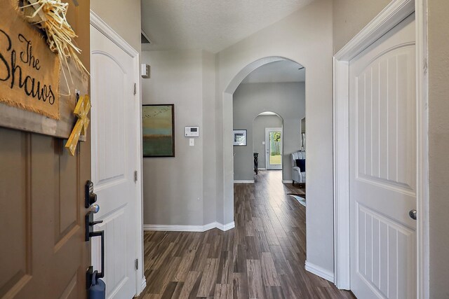 4418 Legends Bay Dr, Baytown, TX 77523 - foyer entrance featuring dark wood finished floors, arched walkways, and baseboards