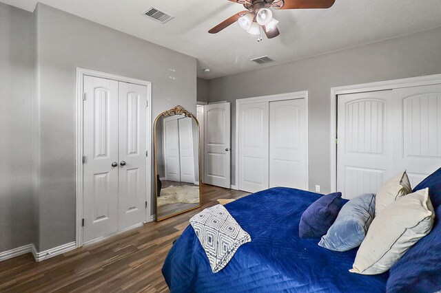 4418 Legends Bay Dr, Baytown, TX 77523 - bedroom featuring multiple closets, wood finished floors, a ceiling fan, and baseboards
