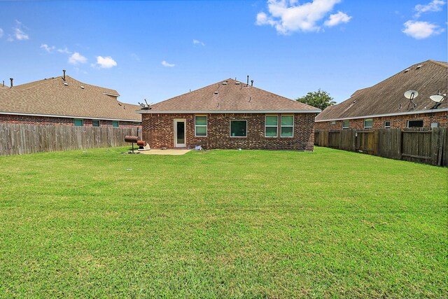 4418 Legends Bay Dr, Baytown, TX 77523 - rear view of house featuring a patio, brick siding, and roof with shingles