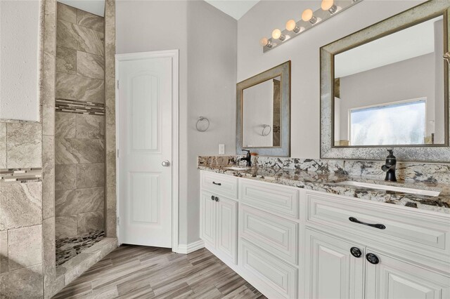 4418 Legends Bay Dr, Baytown, TX 77523 - bathroom with walk in shower, wood finished floors, and double vanity