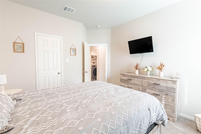 26019 Babe Ruth Dr, Splendora, TX 77372 - bedroom with washer / clothes dryer and light colored carpet