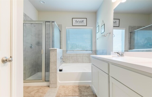26019 Babe Ruth Dr, Splendora, TX 77372 - full bathroom featuring healthy amount of natural light, vanity, a stall shower, and a bath