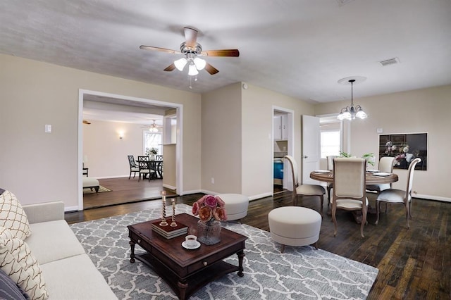 1009 Linden St, La Marque, TX 77568 - living room featuring wood finished floors, a ceiling fan, a chandelier, and baseboards