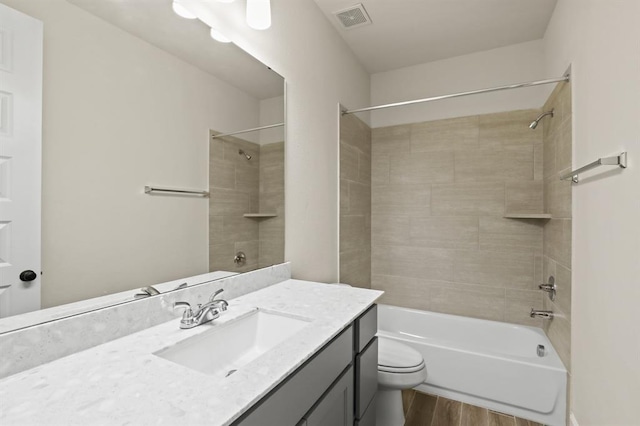 18511 Wolf Mountain Ln, Cypress, TX 77433 - full bathroom featuring vanity, wood finished floors, shower / tub combination, and toilet