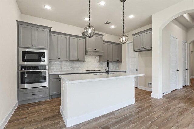 18511 Wolf Mountain Ln, Cypress, TX 77433 - kitchen featuring stainless steel oven, gray cabinetry, built in microwave, baseboards, and recessed lighting