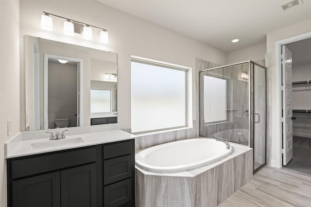 18511 Wolf Mountain Ln, Cypress, TX 77433 - bathroom with a garden tub, a stall shower, vanity, a spacious closet, and toilet