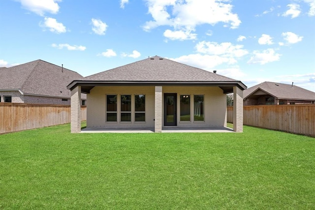 18511 Wolf Mountain Ln, Cypress, TX 77433 - rear view of house with a patio area, brick siding, and a shingled roof