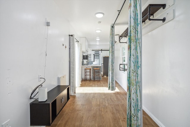 1350 23rd St, San Leon, TX 77539 - hallway featuring wood finished floors and a barn door