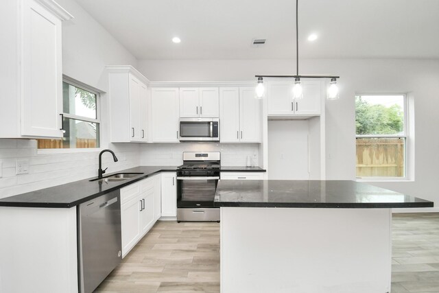 3309 Shelby Cir, Houston, TX 77051 - kitchen featuring stainless steel appliances, a sink, white cabinetry, tasteful backsplash, and recessed lighting