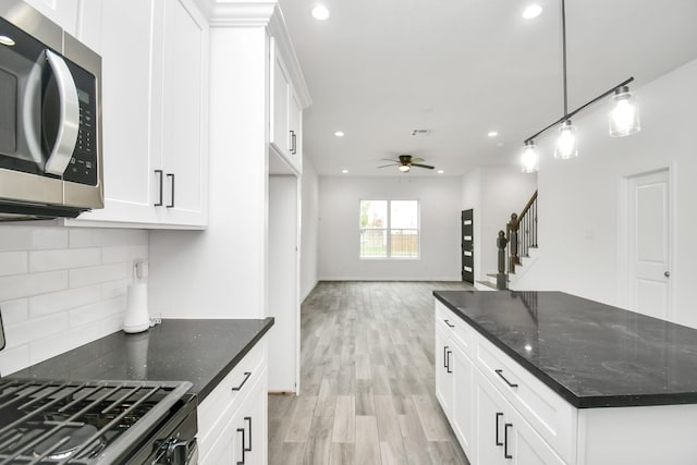 3309 Shelby Cir, Houston, TX 77051 - kitchen with stainless steel microwave, tasteful backsplash, a ceiling fan, light wood finished floors, and recessed lighting