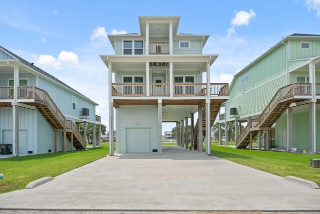 22823 Cuadro St, Galveston, TX 77554 - coastal home with stairs, a carport, an attached garage, driveway, and a front yard