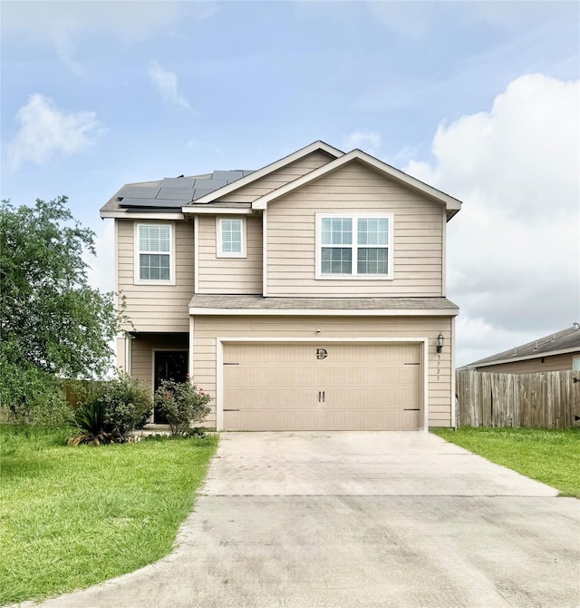 5723 Treasure Cove Rd, Cove, TX 77523 - view of front facade with a garage, roof mounted solar panels, and driveway