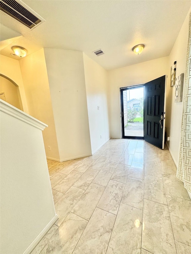 5723 Treasure Cove Rd, Cove, TX 77523 - entrance foyer featuring light marble finish floors and baseboards