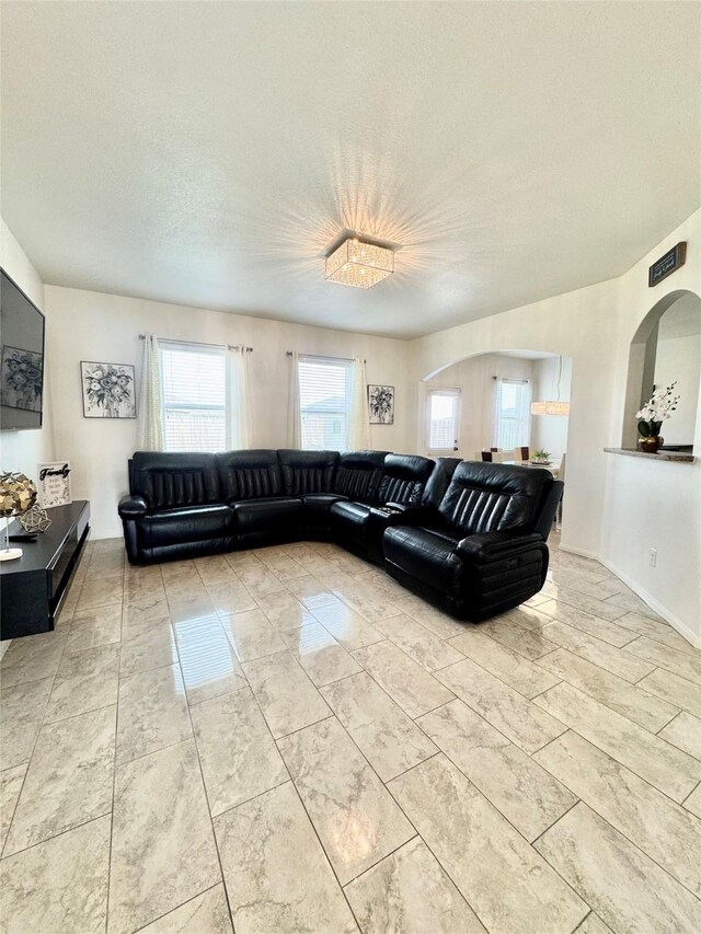 5723 Treasure Cove Rd, Cove, TX 77523 - living room with a textured ceiling and arched walkways