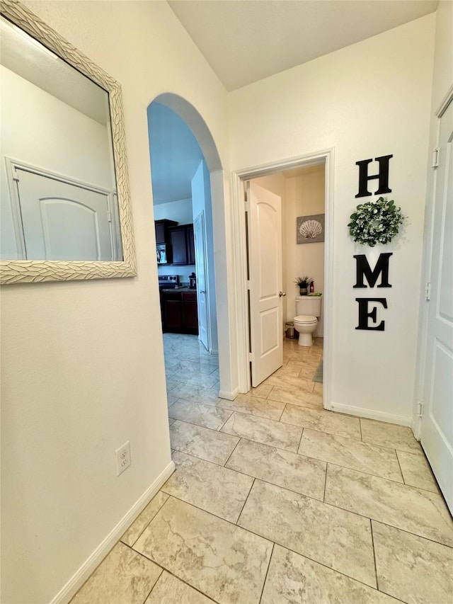 5723 Treasure Cove Rd, Cove, TX 77523 - corridor with arched walkways, baseboards, and light marble finish flooring