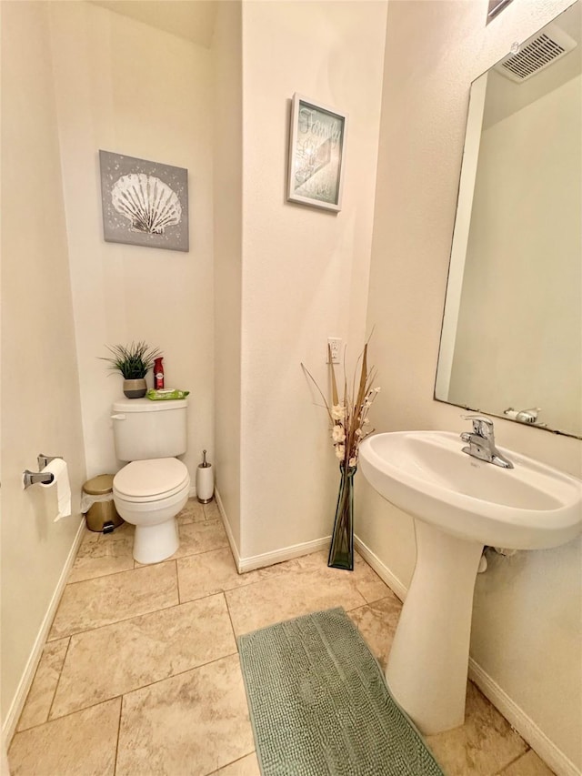 5723 Treasure Cove Rd, Cove, TX 77523 - half bath featuring toilet, baseboards, and tile patterned floors