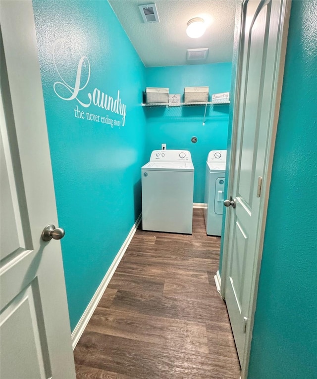 5723 Treasure Cove Rd, Cove, TX 77523 - laundry area with independent washer and dryer, a textured ceiling, wood finished floors, and baseboards
