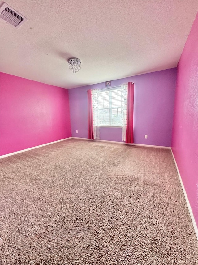 5723 Treasure Cove Rd, Cove, TX 77523 - carpeted empty room featuring a textured ceiling and baseboards
