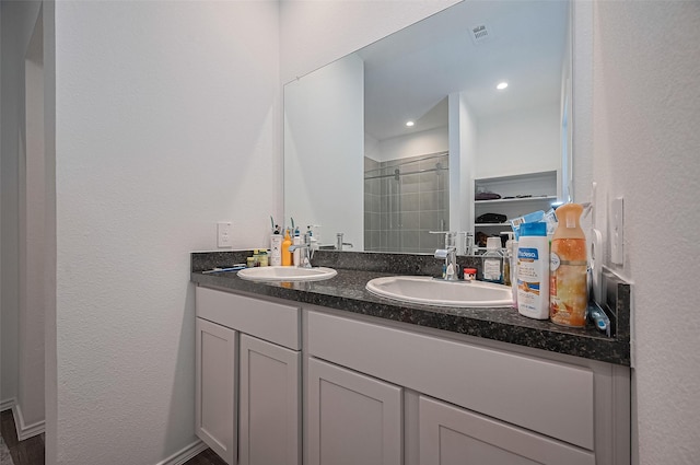 40434 Basalt Elm Rd, Magnolia, TX 77354 - bathroom with a stall shower, double vanity, and a walk in closet