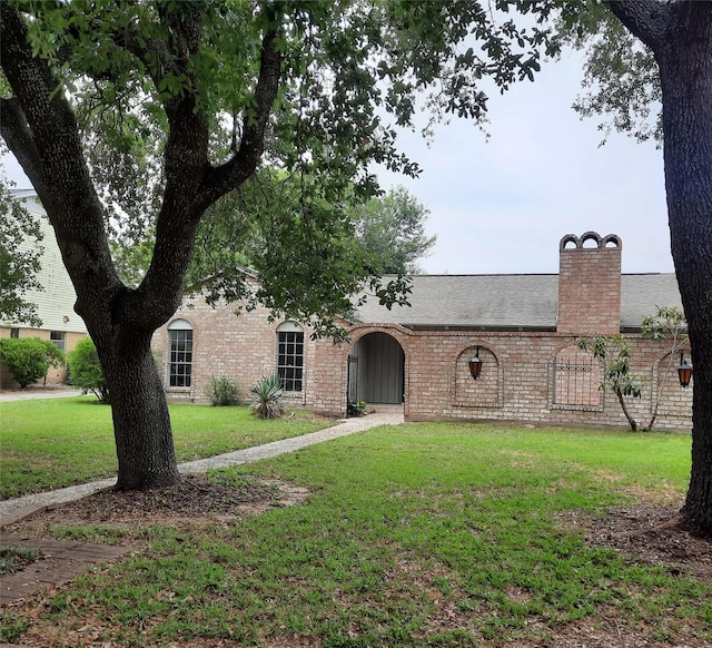 1415 Scenic Ridge Dr, Houston, TX 77043 - view of front of property featuring a front yard, a chimney, brick siding, and a shingled roof