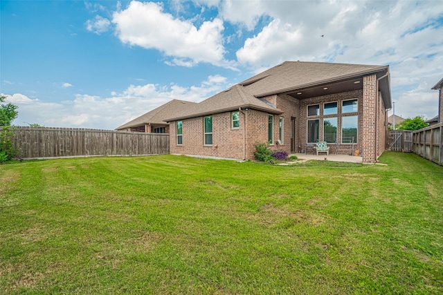 4335 Thornapple Hills Ct, Richmond, TX 77406 - rear view of house featuring a patio, brick siding, and roof with shingles