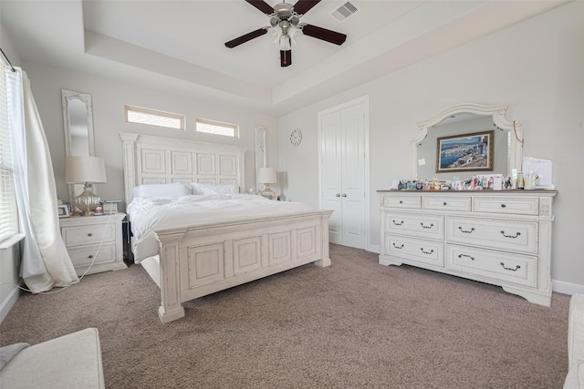 4335 Thornapple Hills Ct, Richmond, TX 77406 - bedroom featuring light carpet, a tray ceiling, ceiling fan, and a closet