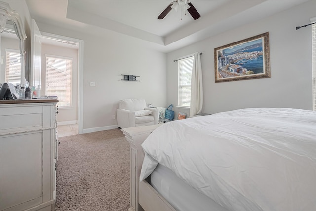 4335 Thornapple Hills Ct, Richmond, TX 77406 - bedroom featuring light colored carpet, a tray ceiling, multiple windows, and a ceiling fan