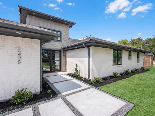 1208 Curtin St, Houston, TX 77018 - view of property exterior with a yard and brick siding