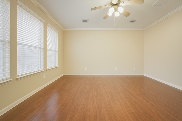 7902 Crystal Moon Dr, Houston, TX 77040 - spare room featuring wood finished floors, ornamental molding, ceiling fan, and baseboards