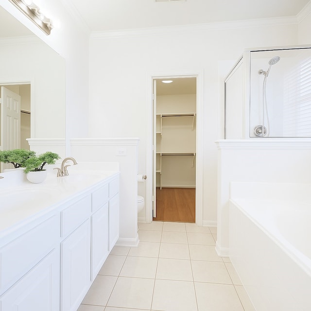 7902 Crystal Moon Dr, Houston, TX 77040 - full bathroom featuring ornamental molding, tile patterned flooring, a spacious closet, a garden tub, and toilet