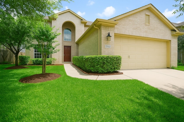 7902 Crystal Moon Dr, Houston, TX 77040 - traditional home with concrete driveway, a front yard, a garage, and brick siding