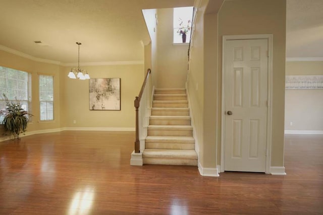 7902 Crystal Moon Dr, Houston, TX 77040 - staircase with wood finished floors, a chandelier, ornamental molding, and baseboards