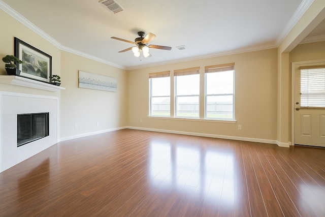 7902 Crystal Moon Dr, Houston, TX 77040 - unfurnished living room featuring crown molding, dark wood-style flooring, a ceiling fan, baseboards, and a tile fireplace
