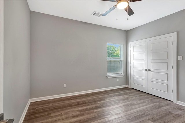 6818 Dumble St, Houston, TX 77021 - unfurnished bedroom with wood finished floors, a closet, baseboards, and a ceiling fan