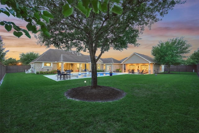 21514 Fairhaven Creek Dr, Cypress, TX 77433 - back of house at dusk with a patio and brick siding