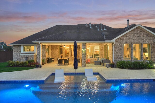 21514 Fairhaven Creek Dr, Cypress, TX 77433 - back of property with outdoor lounge area, a patio, and an outdoor pool