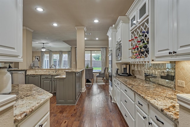 21514 Fairhaven Creek Dr, Cypress, TX 77433 - kitchen featuring recessed lighting, tasteful backsplash, dark wood-style flooring, ceiling fan, and stainless steel microwave