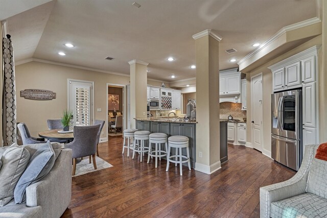 21514 Fairhaven Creek Dr, Cypress, TX 77433 - dining space with decorative columns, ornamental molding, dark wood-type flooring, recessed lighting, and baseboards
