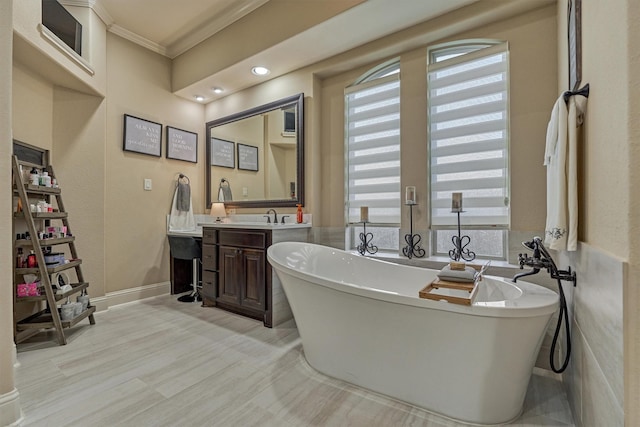 21514 Fairhaven Creek Dr, Cypress, TX 77433 - bathroom featuring crown molding, vanity, a soaking tub, baseboards, and recessed lighting