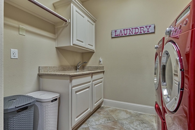 21514 Fairhaven Creek Dr, Cypress, TX 77433 - laundry area featuring cabinet space, baseboards, washer and dryer, and light tile patterned floors