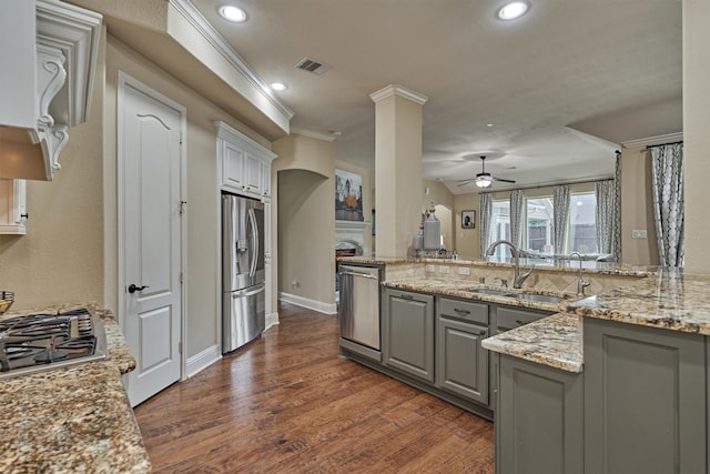 21514 Fairhaven Creek Dr, Cypress, TX 77433 - kitchen with appliances with stainless steel finishes, gray cabinets, ceiling fan, light stone countertops, and dark wood-type flooring