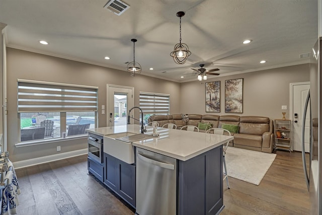 21514 Fairhaven Creek Dr, Cypress, TX 77433 - kitchen with stainless steel appliances, a sink, open floor plan, light countertops, and a ceiling fan