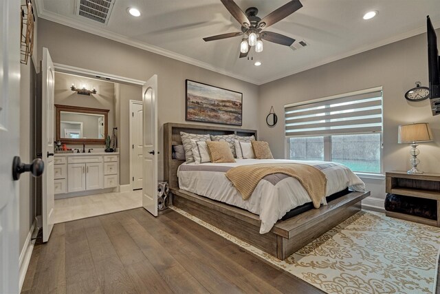 21514 Fairhaven Creek Dr, Cypress, TX 77433 - bedroom featuring recessed lighting, dark wood finished floors, baseboards, ornamental molding, and a sink