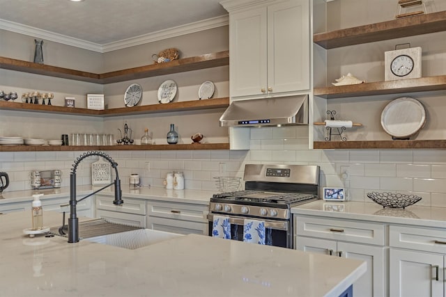 21514 Fairhaven Creek Dr, Cypress, TX 77433 - kitchen featuring stainless steel gas stove, open shelves, wall chimney exhaust hood, crown molding, and decorative backsplash