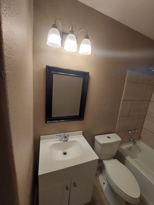 1707 W 7th St, Freeport, TX 77541 - bathroom featuring vanity, toilet, a textured wall, and bathing tub / shower combination