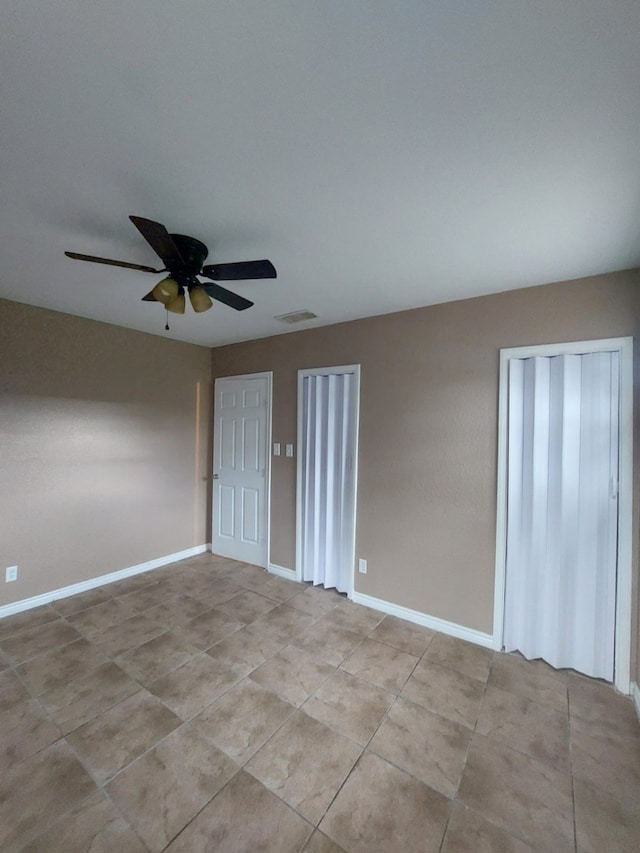1707 W 7th St, Freeport, TX 77541 - empty room with ceiling fan, light tile patterned flooring, and baseboards