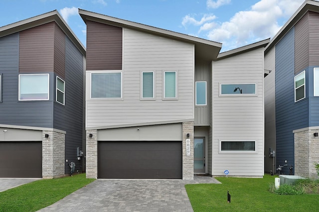6827 Rocinante Ln, Houston, TX 77092 - view of front facade with a garage, stone siding, driveway, and a front yard