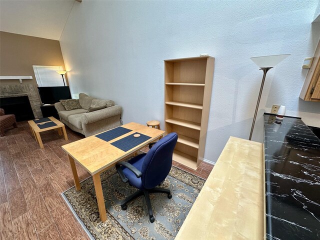 2611 Grants Lake Blvd Unit 237, Sugar Land, TX 77479 - home office with a brick fireplace and wood finished floors